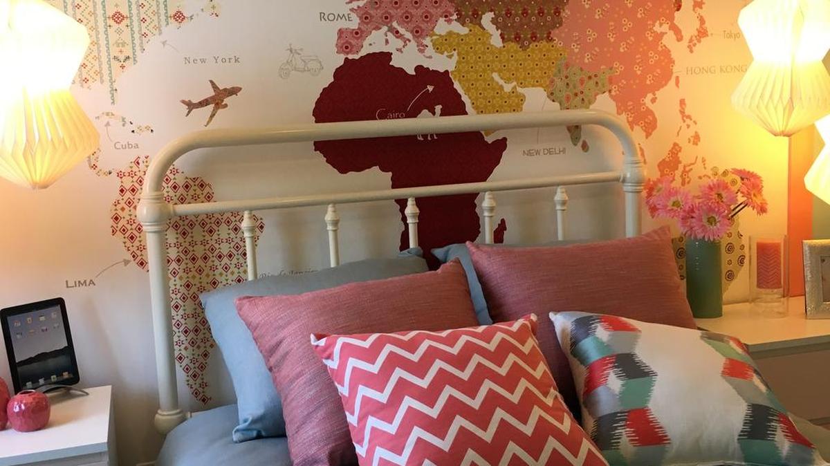 For unique wall decor, cut out various pieces of printed wallpaper in the shapes of the world’s continents.