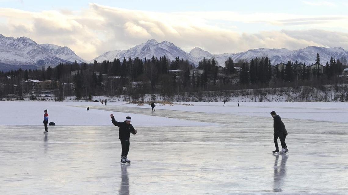 Ice skaters take advantage of unseasonable warm temperatures to ice skate outside at Westchester Lagoon in Anchorage, Alaska, on Jan. 2. Some climate scientists think the immediate concern with climate change is warming, not cooling.