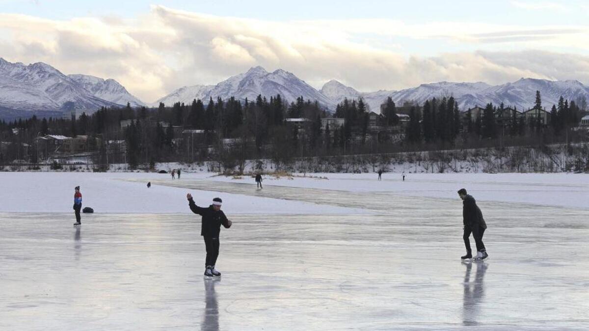Ice skaters take advantage of unseasonable warm temperatures to ice skate outside at Westchester Lagoon in Anchorage, Alaska, on Jan. 2. Some climate scientists think the immediate concern with climate change is warming, not cooling.