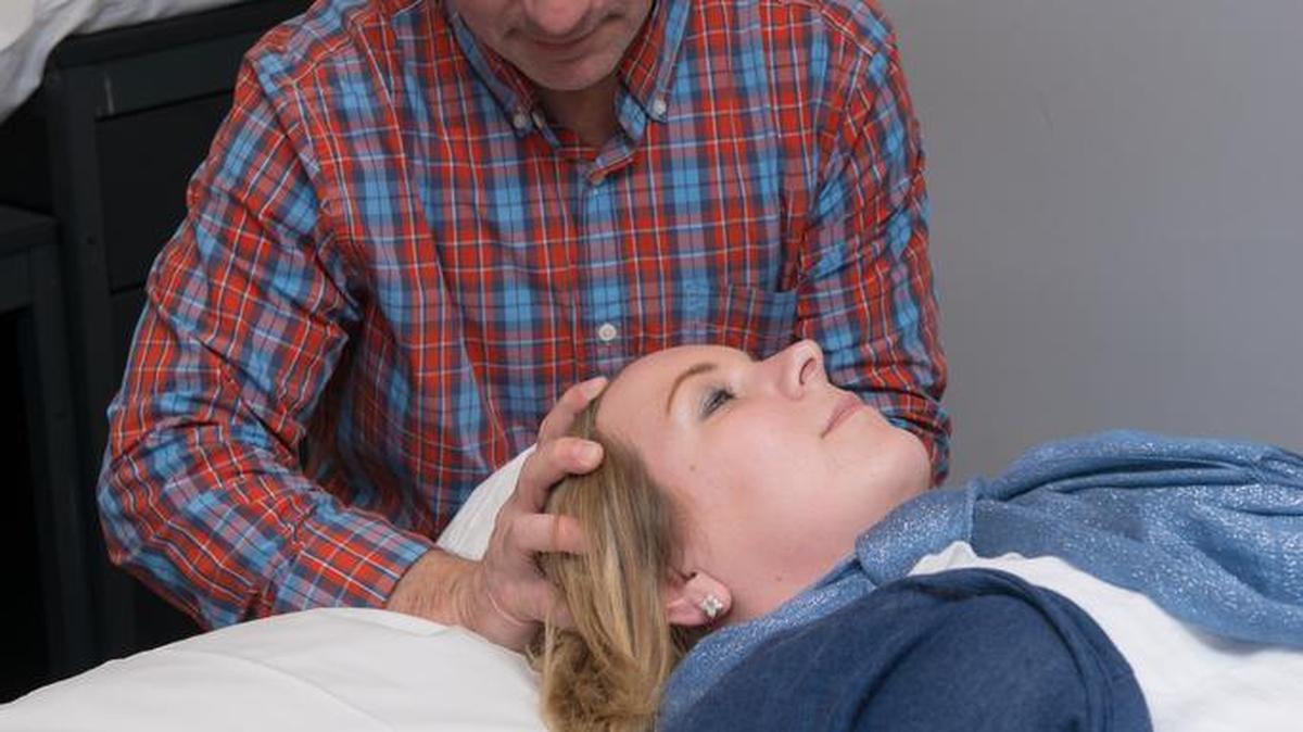 Penn State Orthopedics physical therapist Brian Schulz works with a patient in the State College office.