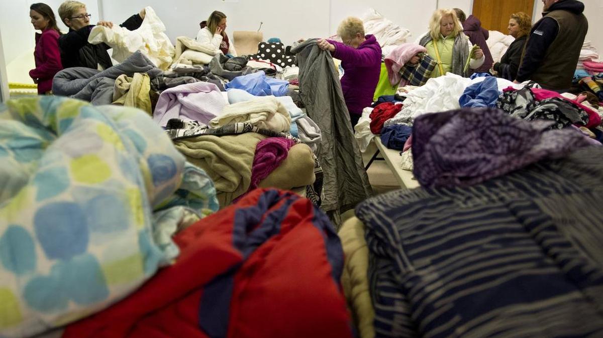 Visitors browse the blankets sheets and towels during the 2015 Trash to Treasure sale. According to research, students who were encouraged to photograph things before giving them away at Trash to Treasure donated 35 percent more items than in the dorms where they didn’t get that prompt.