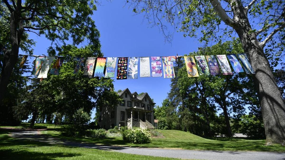 Arts festival banners hang outside the Centre Furnance Mansion in June, celebrating an exhibit on the 50th anniversary of Arts Fest.