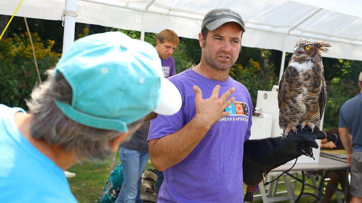 Jon Kauffman, assistant Raptor Center director for Shaver’s Creek Environmental Center, shows attendees a great horned owl during Crickfest, an event hosted by and benefiting the Penns Valley Conservation Association, held on Saturday at Coburn Park. Crickfest featured live music, a silent auction, environmental workshops, conservation exhibits, an animal petting zoo, pony rides, water bottle rockets and other attractions.