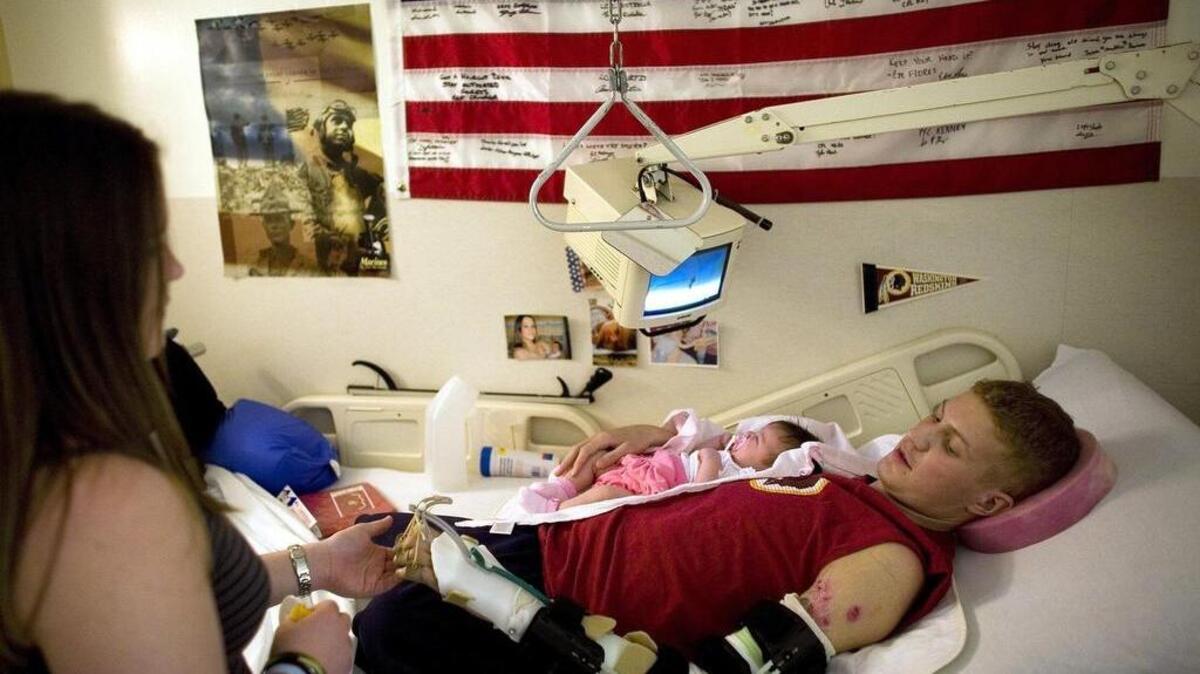Sgt. David Emery Jr. cradles his daughter Carlee at Walter Reed Army Medical Center in Washington, D.C. The Bellefonte man was awarded a Purple Heart after being wounded by the blast from a suicide bomber while serving in Iraq.