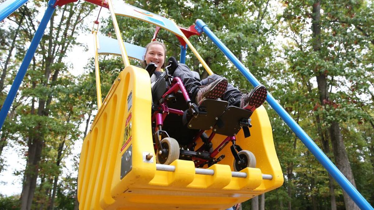 Miranda Fleck smiles as she swings on the recently-installed Liberty Swing on Oct. 8 at Governors Park in Bellefonte.