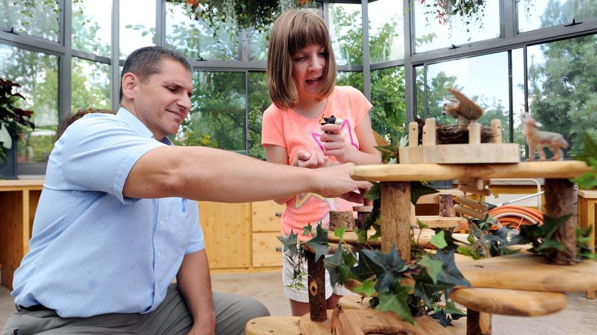 Jeff Steiner and his daughter Alexa, 13, play with an animal sculpture Tuesday at The Arboretum at Penn State. Steiner is the executive director of the Dads’ Resource Center.