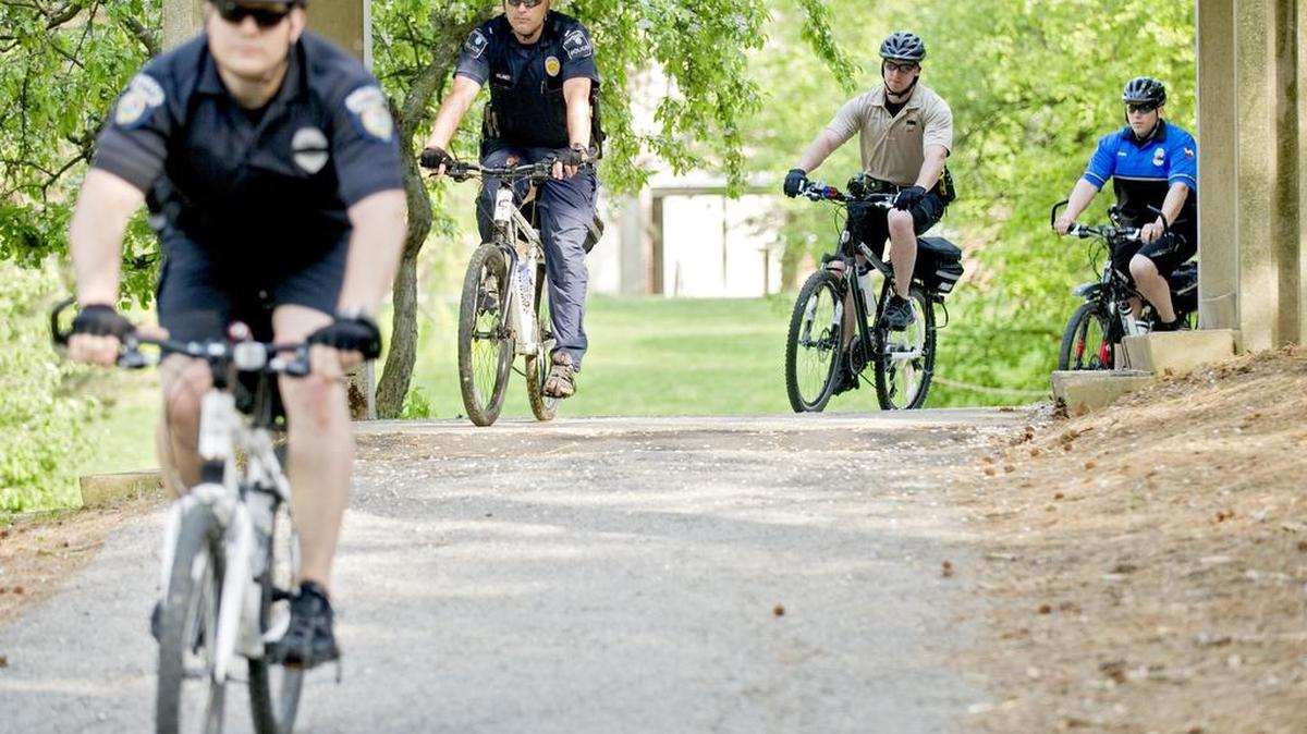 Police officers ride through campus during the Penn State police-hosted training for the International Police Mountain Bike Association in 2014.