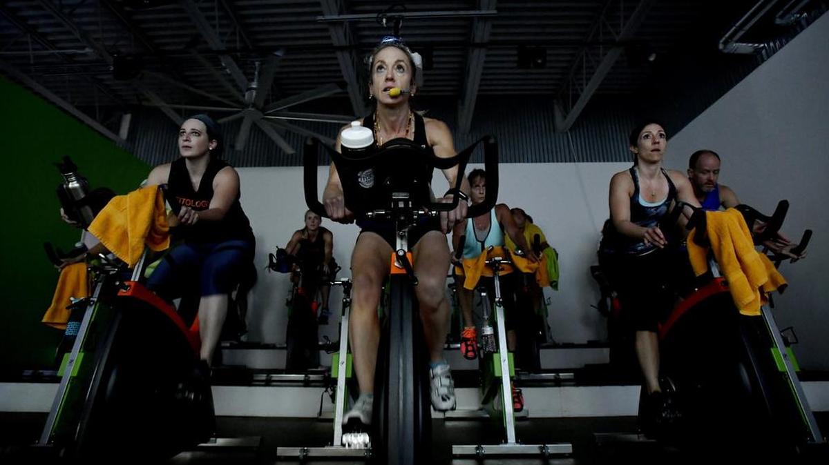 Claire Colebrook teaches a LesMills “The Trip” cycling class at Fitology on Tuesday.