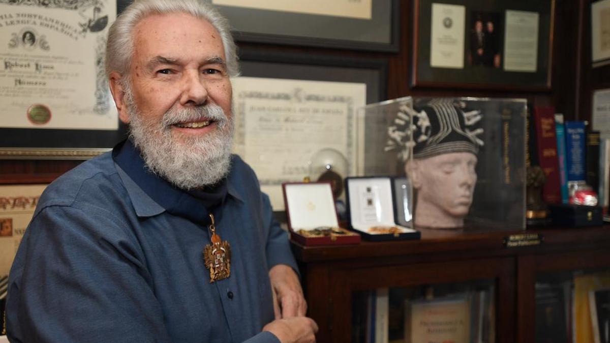 Robert Lima poses for a portrait while wearing his Knight Commander in the Imperial Hispanic Order of Charles V medal on Monday at his home in State College.