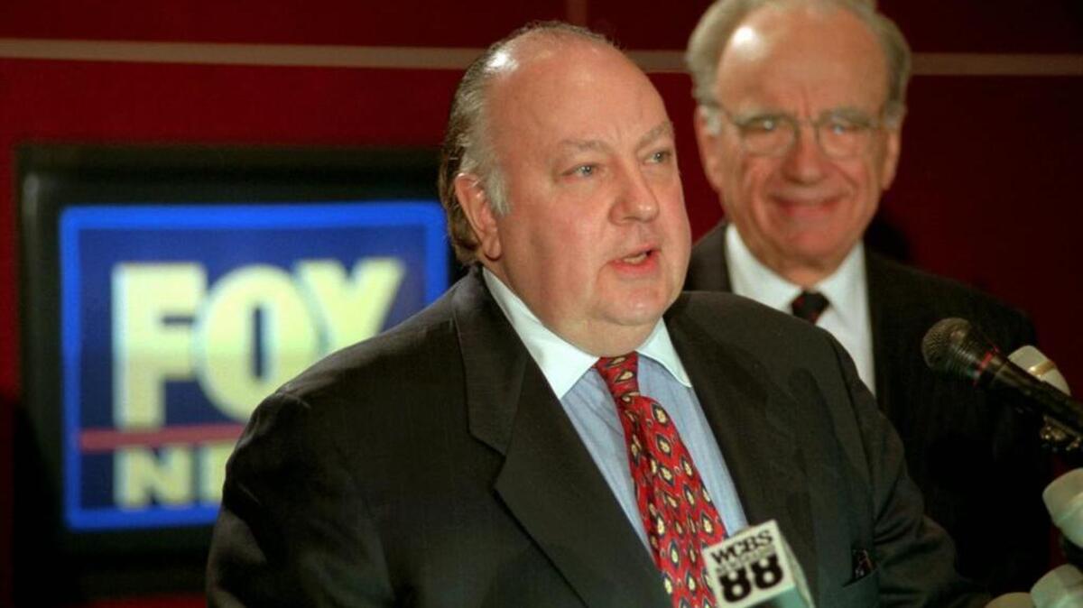 Roger Ailes, left, speaks at a news conference in 1996 as Rupert Murdoch looks on after it was announced that Ailes will be chairman and CEO of Fox News. 21st Century Fox announced July 21 that Ailes is resigning immediately.