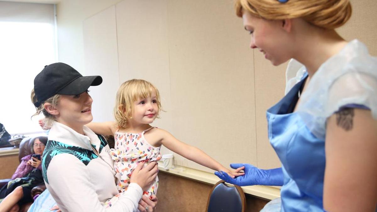 Annalee Capiro holds Annie Bates, 3, as she meets Cinderella during the Alliance of Heroic Hearts “hero visit” for the Pennsylvania Deaf-Blind Project Family Learning Conference on Saturday at the Penn Stater Hotel and Conference Center.