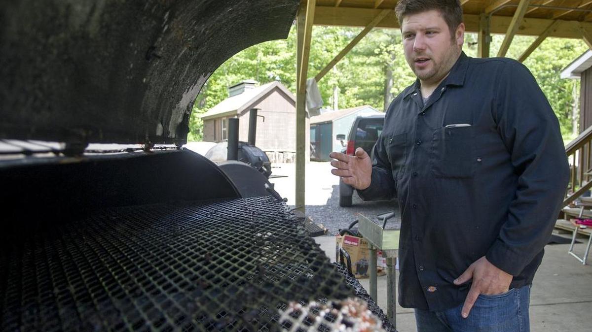 Brandon Corvin, of Doan’s Bones Barbecue, talks about the smoking process he uses for the meats on Wednesday. Beef prices have recently started to decline after a lengthy climb.