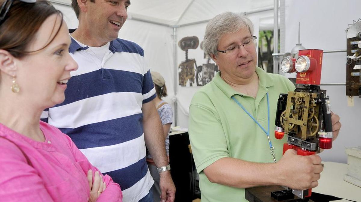 Dan Baxter, of State College, shows of one of his robots to visitors in his booth during the Central Pennsylvania Festival of the Arts in July 2013. Baxter creates his robots out of antique objects he collect at yard sales, flea markets and off the Internet.