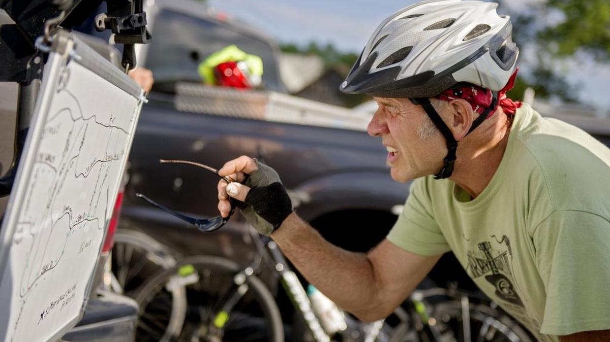 Bob Vernon looks at the map for the evening’s 18-mile ride with Penns Valley Pedals and Pints bike club on June 30.