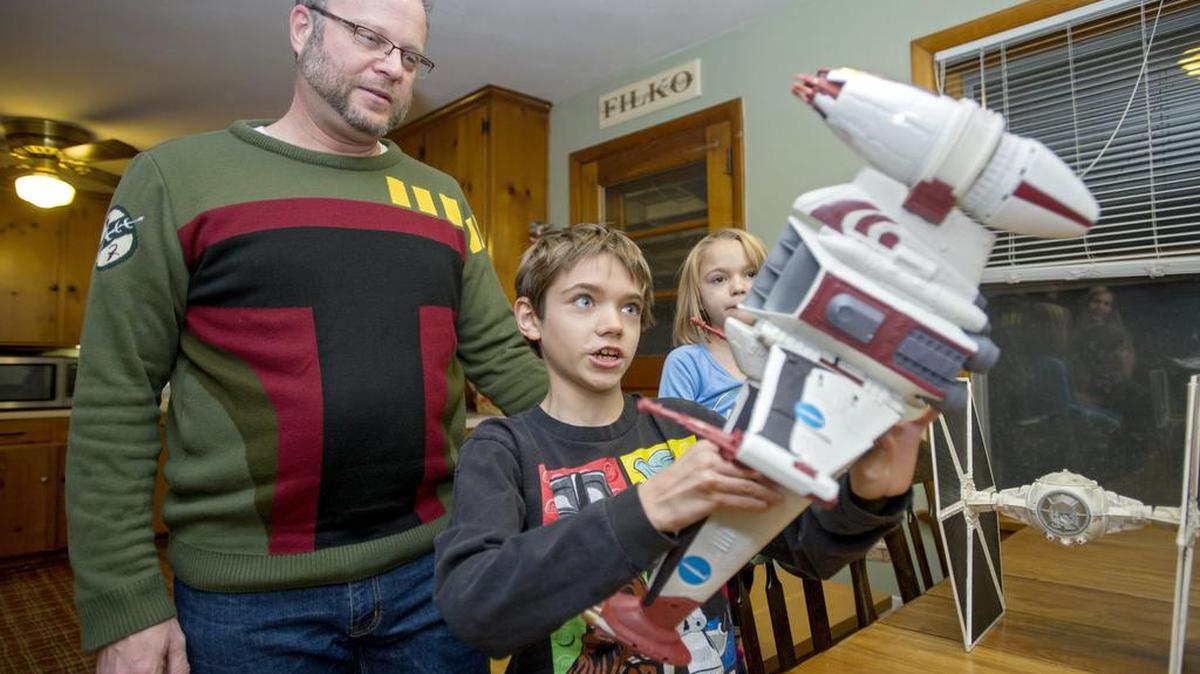 Jeff Filko watches as he son Lukas, 10, shows off a B Wing toy at his home. Filko told his wife, Kimbr, before they were even married that he wanted to name a son Lukas, after famous Star Wars creator George Lucas.