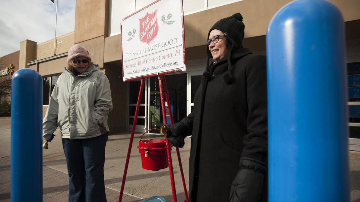 Elin Kjelgaard, left, and Betty Ellen Barrett ring bells at a Salvation Army kettle outside of Wal-Mart on North Atherton Street on Thursday.