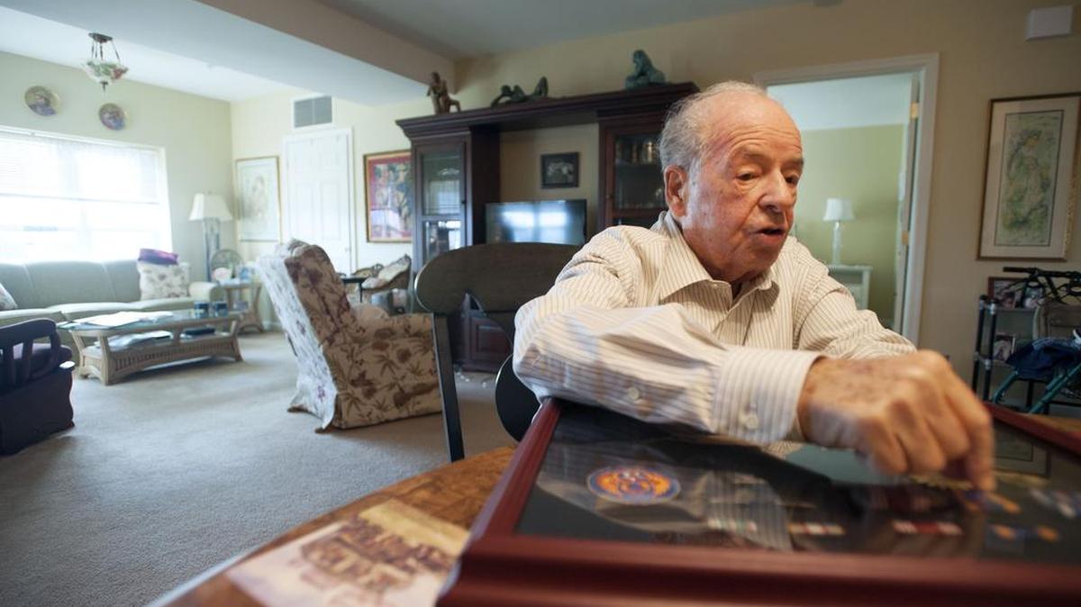 World War II veteran Morton Kimmel discusses the medals he’s received on Dec. 5 at The Village at Penn State. He was recently awarded the French Chevalier of the Legion of Honor.
