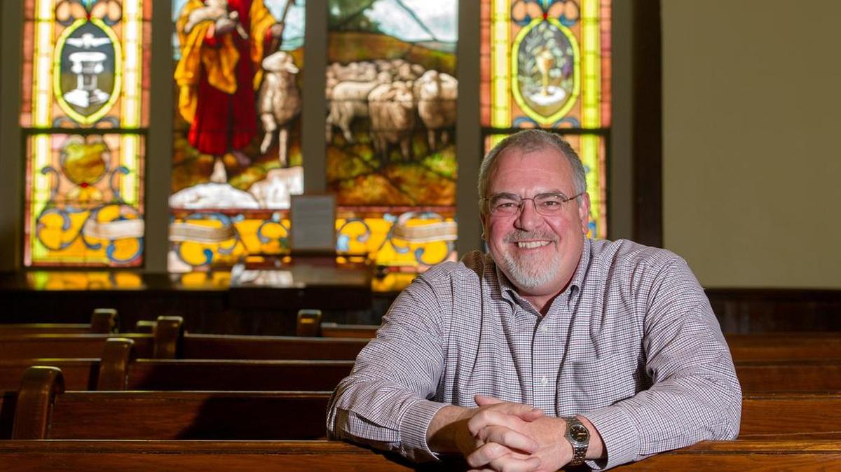 Pastor Dave Downer poses for a photo in the sanctuary of Trinity United Church of Christ in Centre Hall.