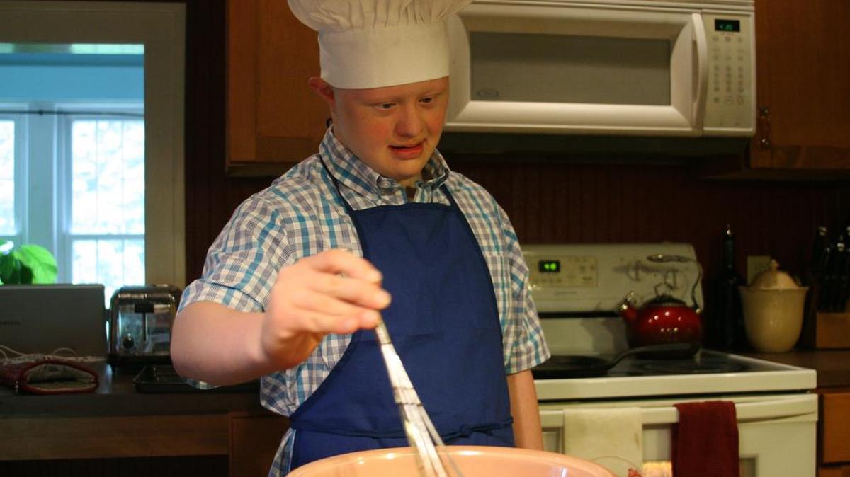 Sam Moyer works on a recipe. His sister, Anna Moyer, developed the website “Your Special Chef,” which uses visual recipes to help teach food prep skills to people with disabilities.