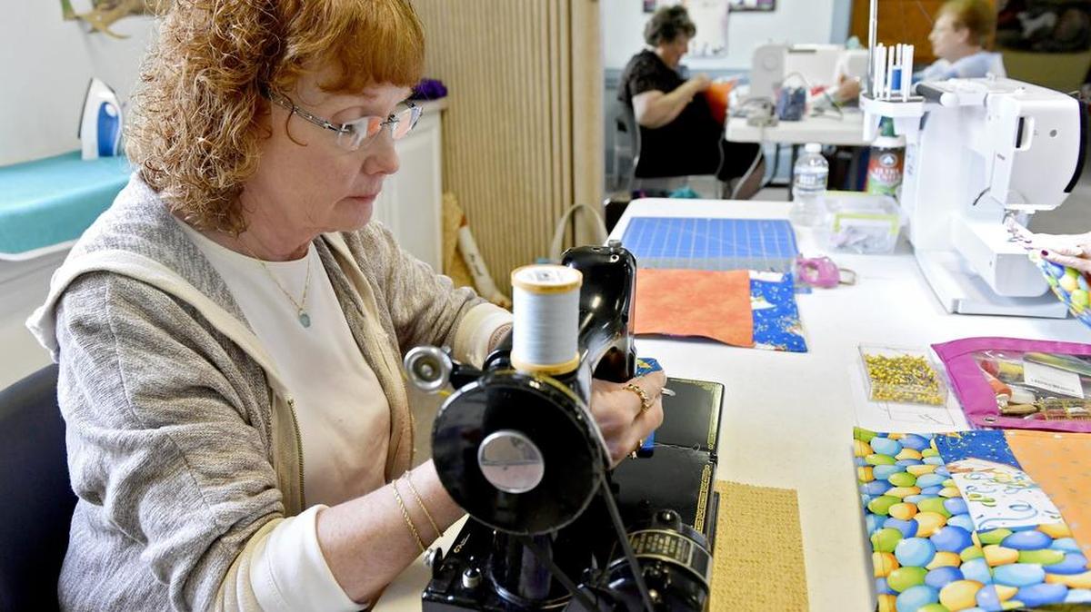 Debbie Barrick works on a birthday placemat with fellow members of the Centre Pieces Quilt Guild on Sept. 13 at St. John’s Church in Boalsburg. The club quilted birthday themed placemats to be delivered with Meals on Wheels.