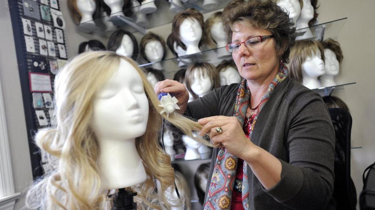 Janise Crow styles a wig in her State College studio on March 15.