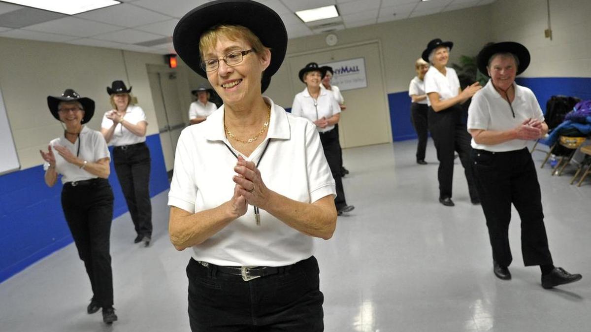 Ginny Mulhatten leads a line dance during a Silver Spurs Line Dancers rehearsal at the Nittany Mall on Feb. 10.