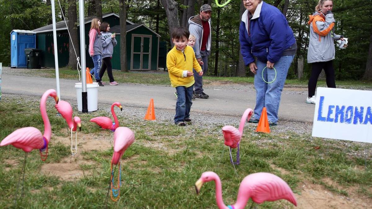 Debbie King and her grandson, Trey Weiser throw rings on toy flamingos during Bellefonte’s Relay for Life at Governors Park.