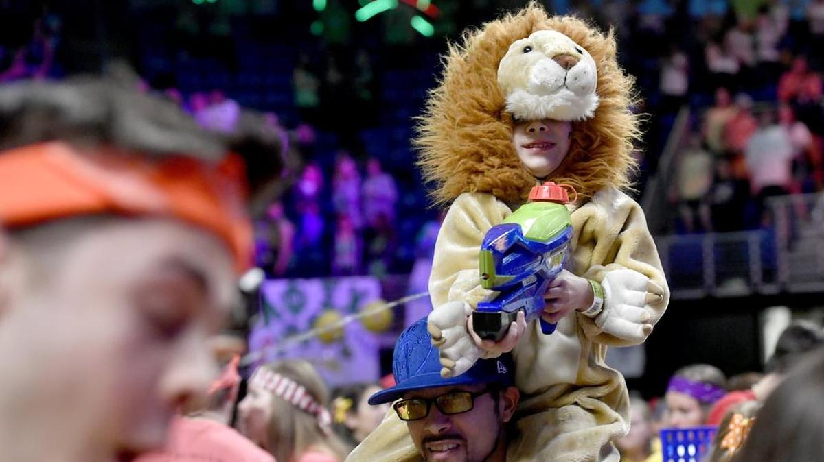 From the top of his dad’s shoulders, Romeo Rodriguez shoots his water gun at dancer relations members during the 2018 Penn State IFC/Panhellenic Dance Marathon.