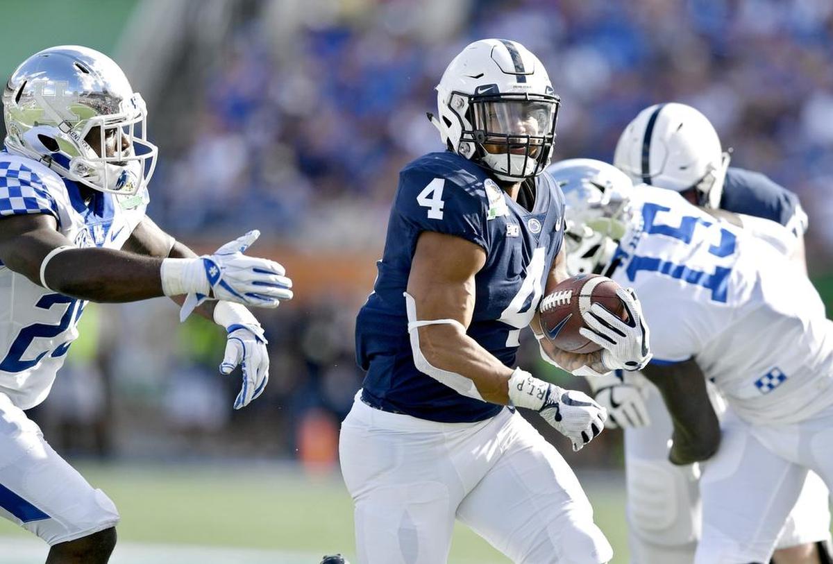 Penn State running back Ricky Slade outruns a Kentucky defender during the Citrus bowl on Tuesday, Jan. 1, 2019 at Camping World Stadium.