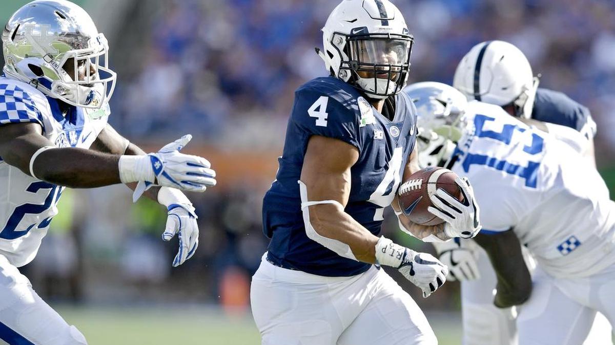 Penn State running back Ricky Slade outruns a Kentucky defender during the Citrus bowl on Tuesday, Jan. 1, 2019 at Camping World Stadium.