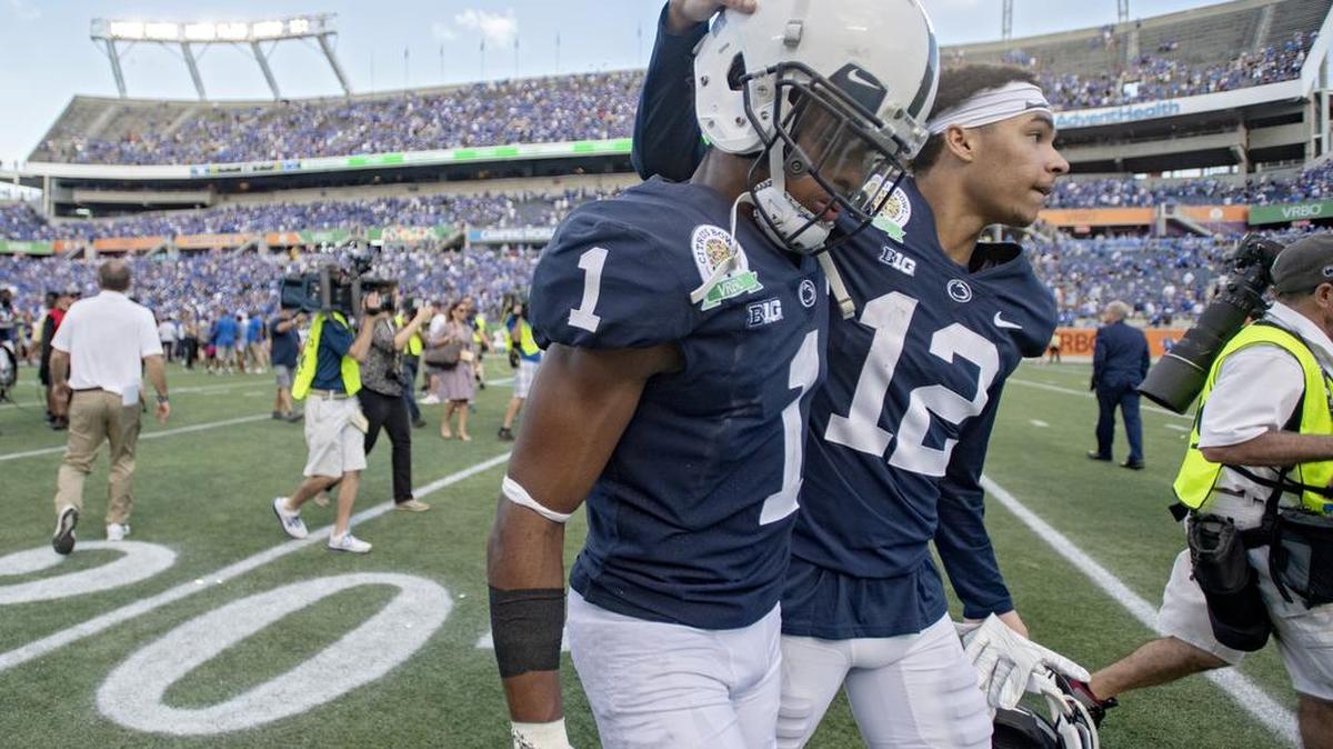 Penn State wide receivers KJ Hamler and Mac Hippenhammer walk off the field in disappointment after the loss to Kentucky in the Citrus Bowl on Tuesday, Jan. 1, 2019 at Camping World Stadium.