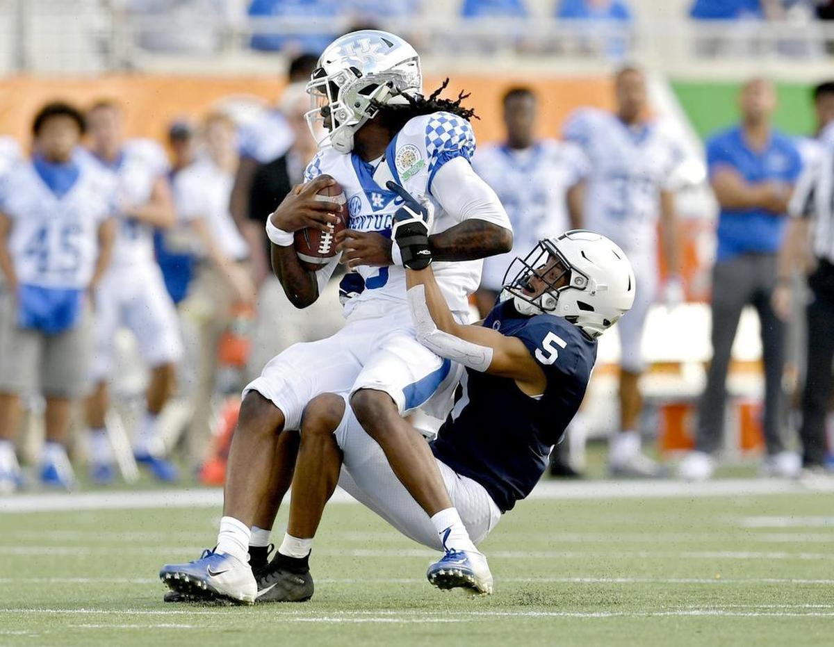 Penn State cornerback Tariq Castro-Fields pulls down Kentucky quarterback Terry Wilson during the Citrus Bowl on Tuesday, Jan. 1, 2019 at Camping World Stadium.