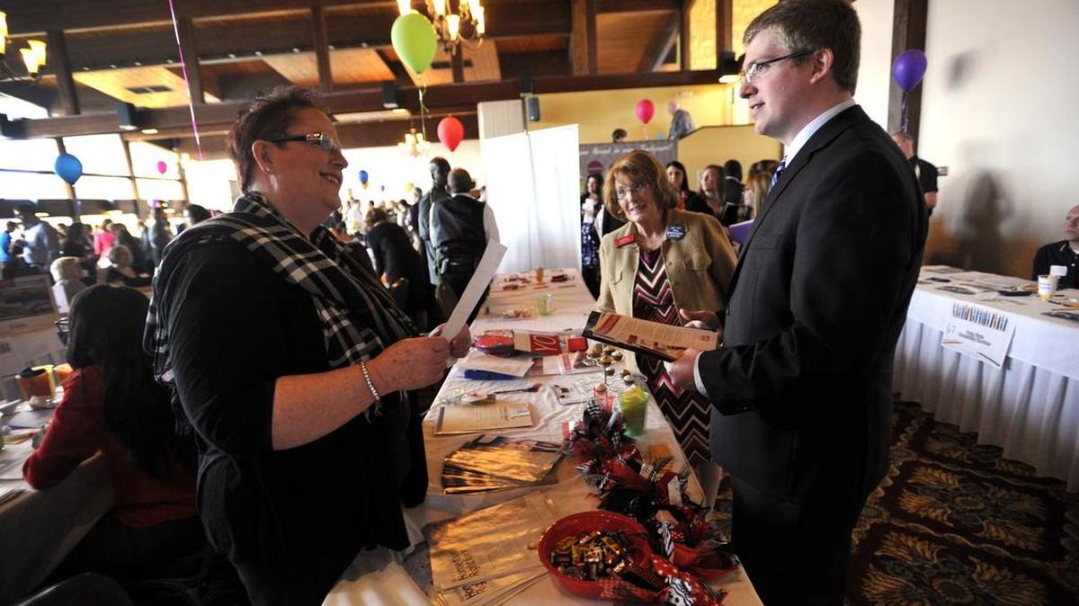 Mary Pat Dolan, left, and Lorraine Spock, middle, with Keller Williams Realty, talk with student Corey Knight about the real estate business. South Hills School of Business & Technology held its Network & Career Fair at Mountain View Country Club in Boalsburg March 31, 2016.