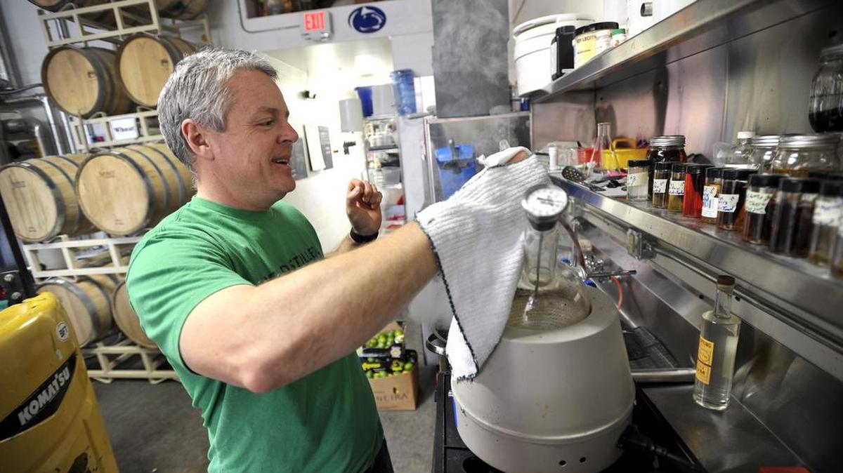 Big Spring Spirits co-owner Kevin Lloyd works on checking the proof of a batch of gin at the Bellefonte distillery on March 3.