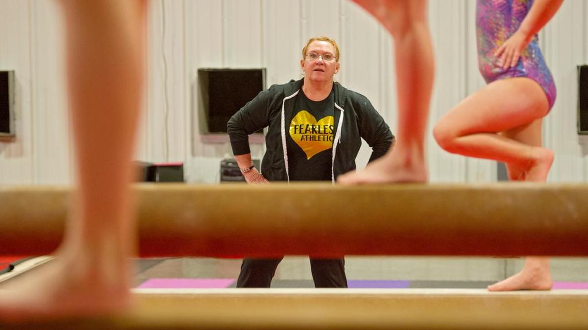 Amy Glunt coaches an advanced gymnastics class on the beam at Fearless Athletics on Monday, December 21, 2015.