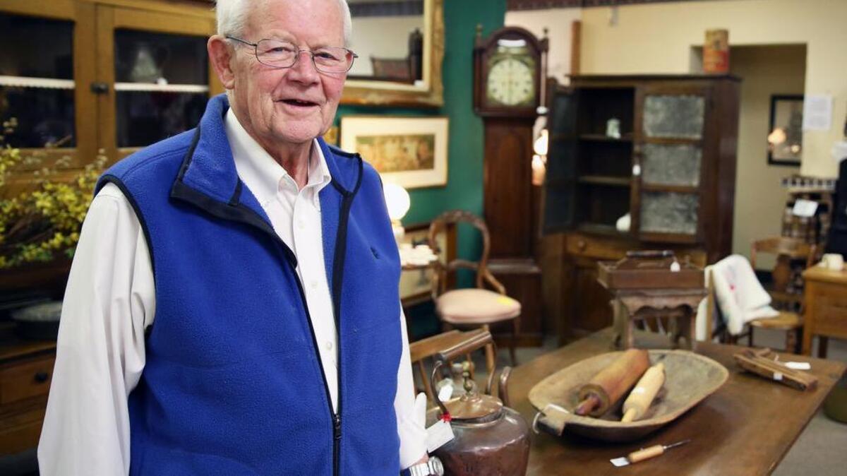 Roger Snyder stands for a portrait Tuesday at Apple Hill Antiques. The store is celebrating its 20th anniversary this month.