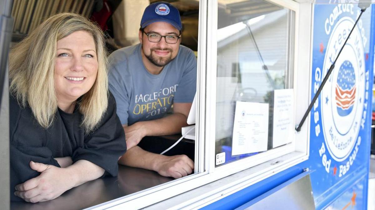 Susan Smith-Shannon and Quentin Rodriguez pose in the new Street Meat food truck that is part of Mountain View Farm.