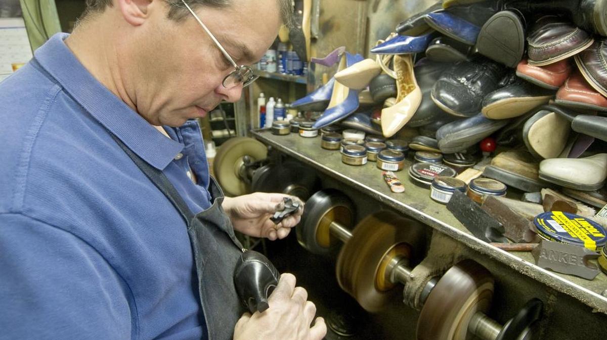 Angelo Card owner of Custom Shoe Repair polishes shoes on Wednesday, March 9, 2016.