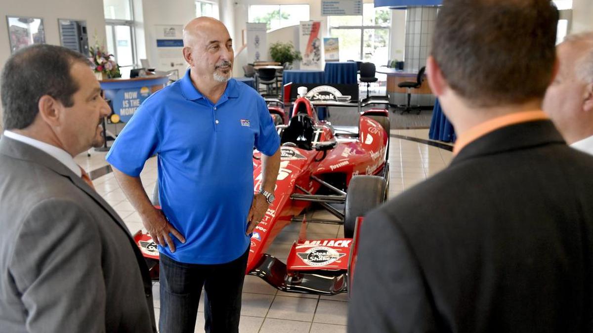 Bobby Rahal chats with visitors in his new Honda dealer in State College during an opening reception on Aug. 31.