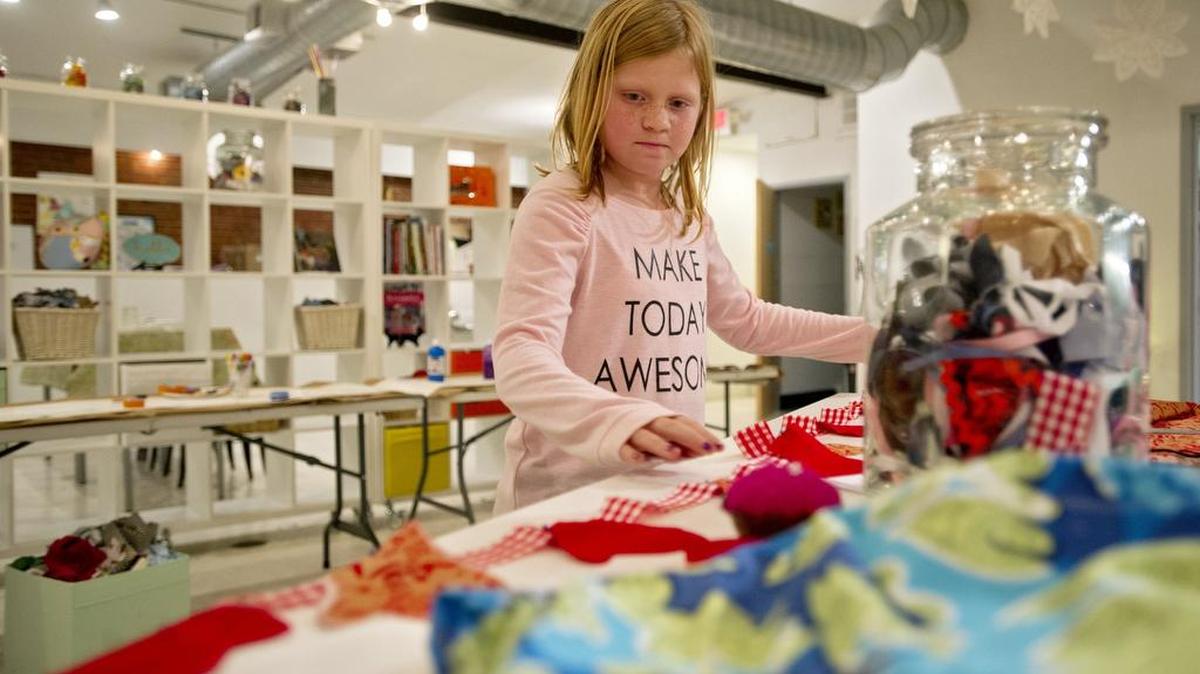 Lilly Shaha, 10, works on a stocking decoration during open sewing at the Makery on Thursday, December 3, 2015.
