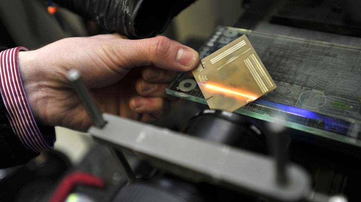 Ben Hall, co-founder of Lasers for Innovative Solutions, shows the laser as it is projected on a board in March 2015. Lasers for Innovative Solutions is a Penn State incubator business that works on laser processing and is one of many tech companies in the region.