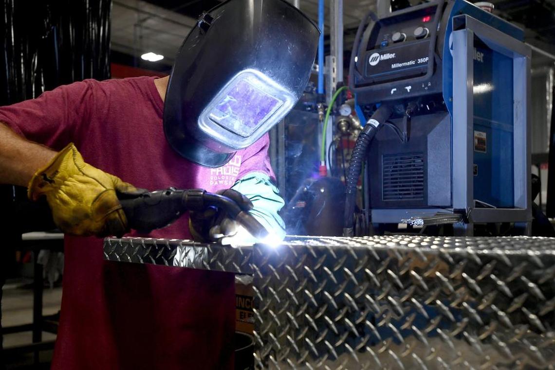 DiamondBack employee Derb Hummel welds parts of a truck cover together in July 2017 in the company’s facility in the Moshannon Valley Regional Business Park.