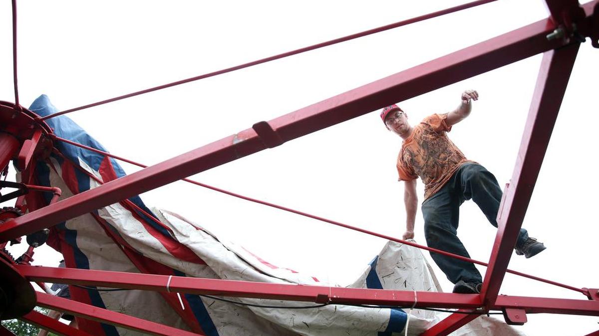 Brad Miller sets up the Garbrick Amusements carousel ride on Monday at the Centre County Grange Encampment and Fair.