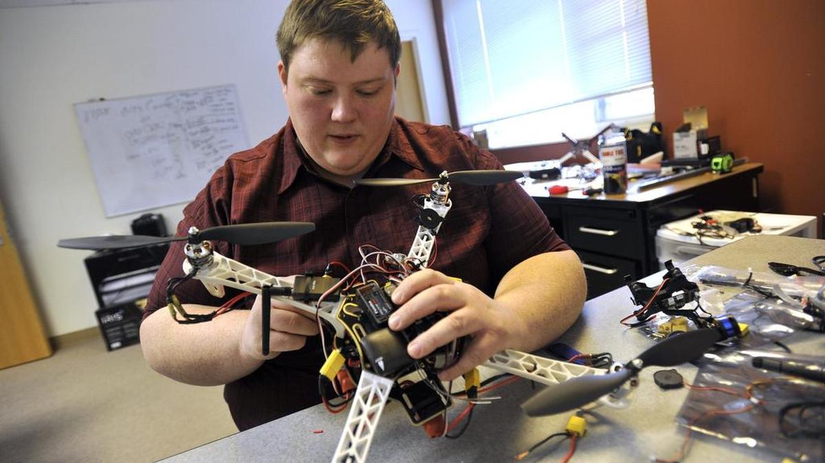 Justin Miller, of State College-based Airnest, formerly Ares Drones, works on a drone in his office.