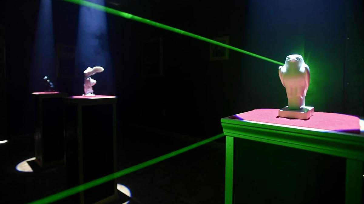 Lasers and statues in the “Louvre” in the Stealing Mona escape room at IQ Escape. IQ Escape has opened on Hamilton street and is State College’s first escape room.