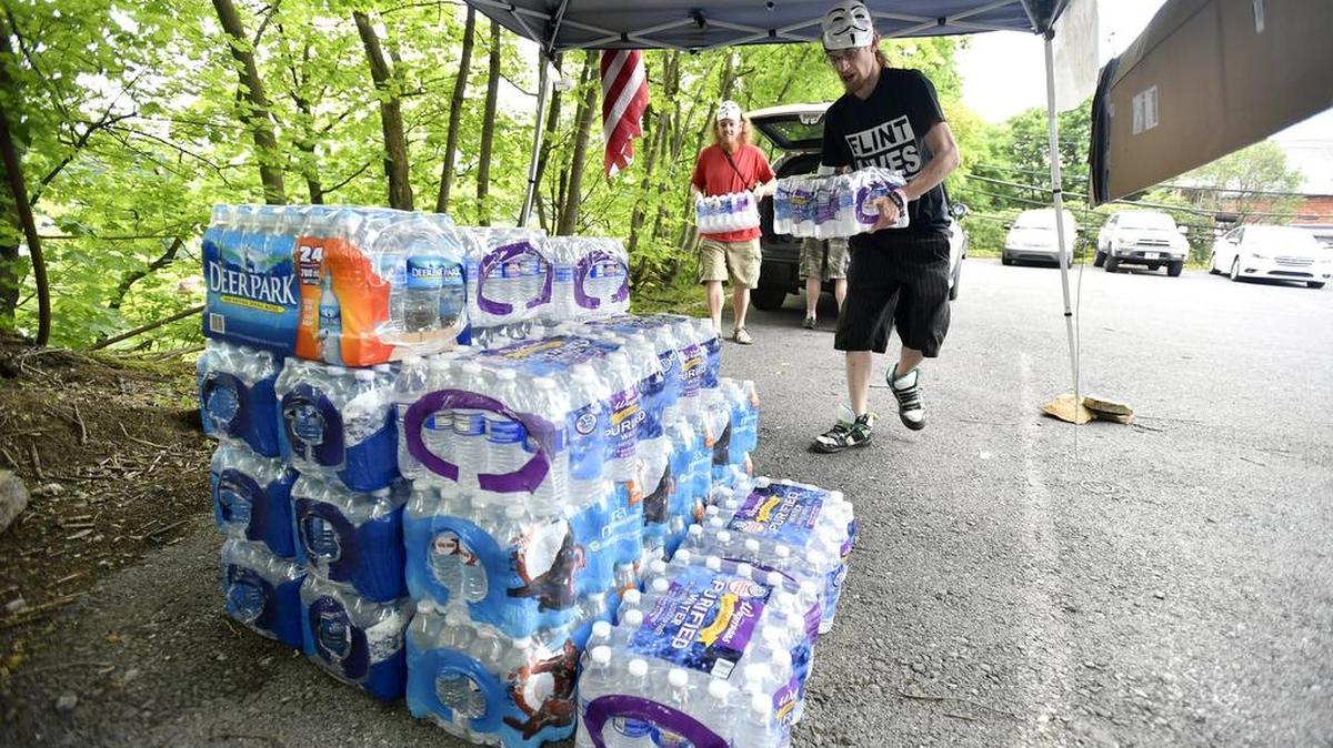 Matt Grove, left, and John Adams unload cases of water donated by Wegmans. Adams is helping lead a local effort to collect water for the people of Flint, Mich. Water and other donated items have been collected at the Bellefonte VFW.