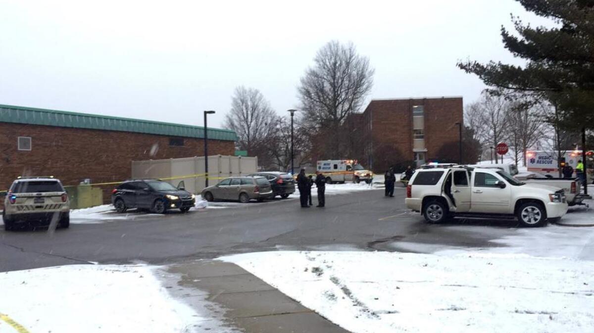 Authorities investigate the scene of a shooting at the Penn State campus in Monaca, Beaver County, Wednesday, Dec. 13, 2017. Police say a woman who worked at a Penn State satellite campus was apparently shot dead in the university parking lot by her estranged husband and the man then killed himself.
