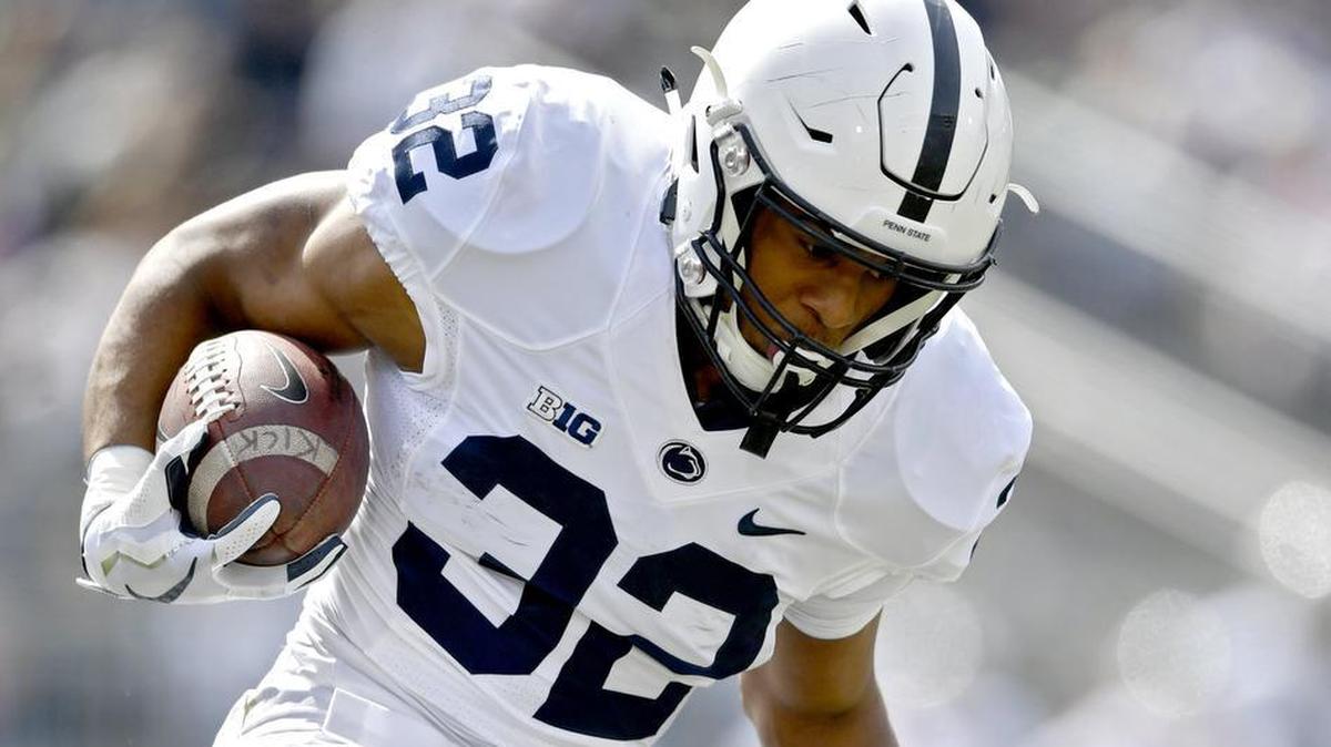 Penn State running back Journey Brown runs down the field with the ball from a defender during the Penn State Blue-White Game on Saturday, April 21, 2018.