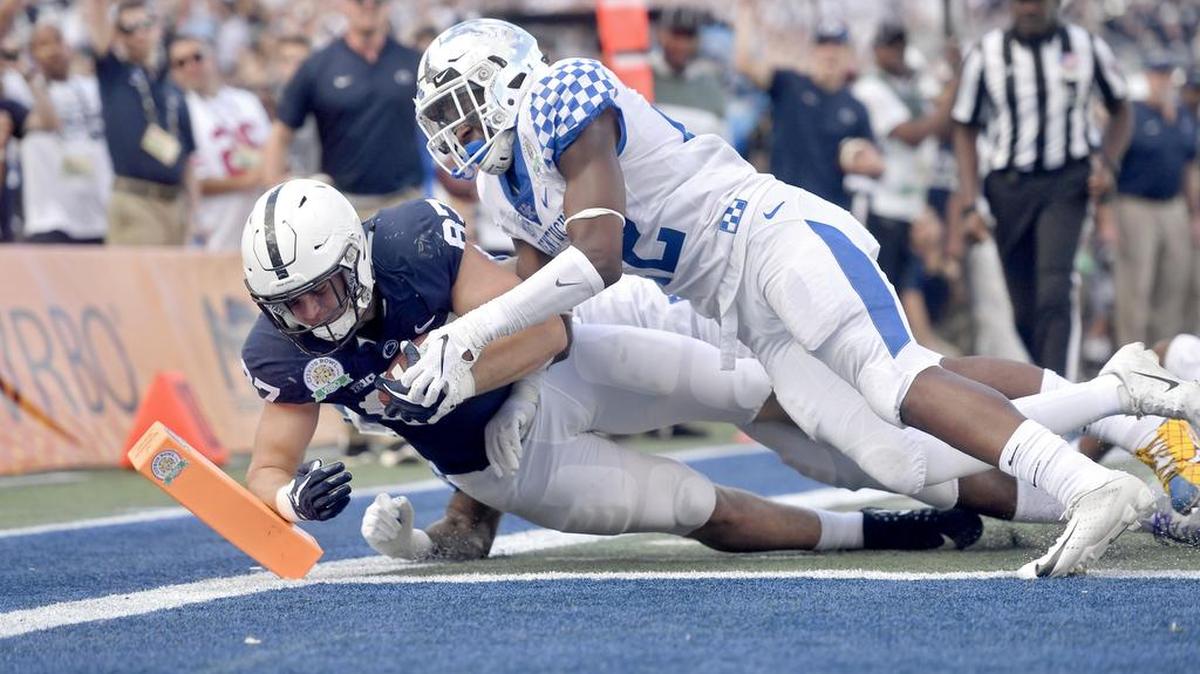 Kentucky defenders can’t stop Penn State tight end Pat Freiermuth as he dives into the end zone for a touchdown during the Citrus Bowl on Tuesday, Jan. 1, 2019 at Camping World Stadium.