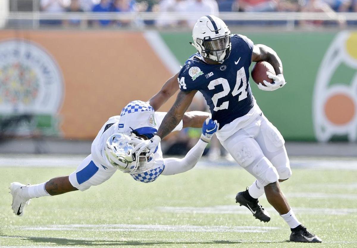 Penn State running back Miles Sanders tries to push off the tackle from Kentucky safety Davonte Robinson during the Citrus bowl on Tuesday, Jan. 1, 2019 at Camping World Stadium.
